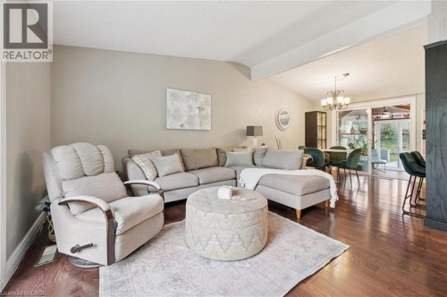 Spacious living area featuring vaulted ceilings, wood-finish flooring, and neutral wall tones - 100 Forest Hill Drive, Kitchener, ON 