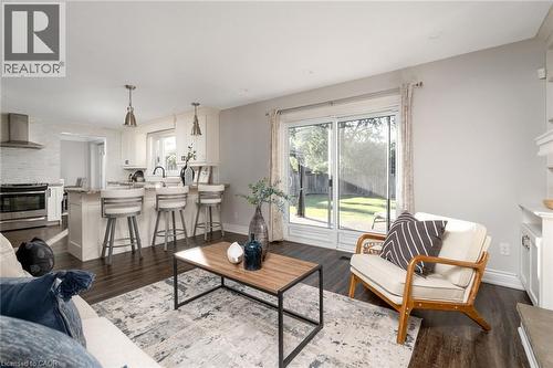 Open-concept living area featuring dark wood-finish flooring and light-toned walls - 20 San Marino Crescent, Hamilton, ON 