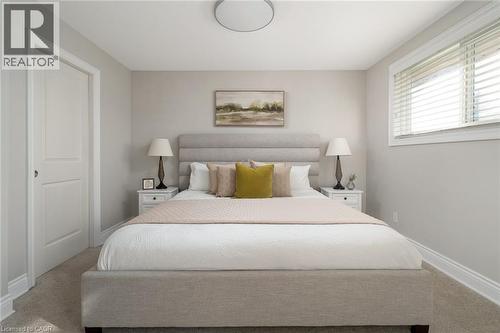 Bedroom featuring light neutral wall paint, carpet flooring, a white two-panel door, and a horizontal window with blinds - 20 San Marino Crescent, Hamilton, ON 