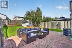 Paved patio area, manicured lawn, wood privacy fencing, outdoor storage shed, and a built-in gazebo - 