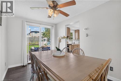 Sliding glass door to the backyard, laminate flooring, and a ceiling fan with integrated lighting - 38 Meadow Woods Crescent, Kitchener, ON 