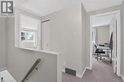 Carpeted upper level featuring light gray painted walls, white trim, - 