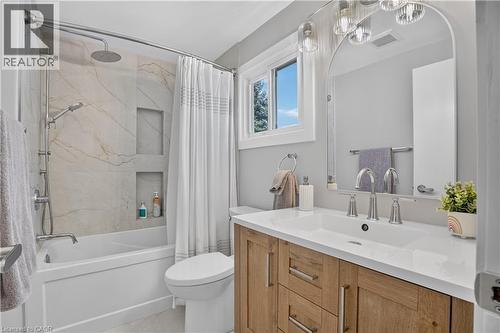 Wood-finish vanity with a white countertop and undermount sink - 38 Meadow Woods Crescent, Kitchener, ON 
