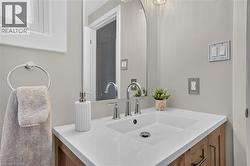 Integrated rectangular sink with a white countertop, wood-finish vanity, and polished chrome faucet - 