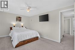 Neutral wall color, wall-mounted television, and overhead ceiling fan - 