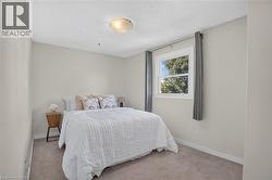 Neutral-toned walls complement the light-colored carpet, creating a bright atmosphere - 