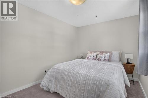 Carpeted flooring and light-toned walls - 38 Meadow Woods Crescent, Kitchener, ON 