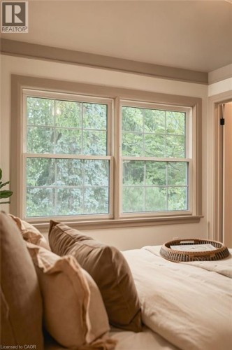 Two double-hung windows with muntins, framed by substantial trim - 571 Leonard Court, Burlington, ON 