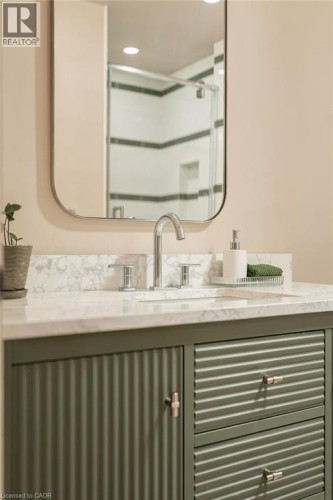 Vanity with a light-toned countertop, chrome faucet, and integrated sink - 571 Leonard Court, Burlington, ON 
