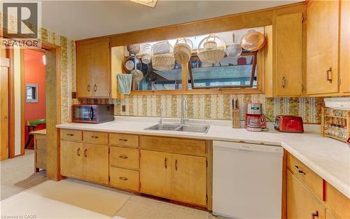 Kitchen featuring wood cabinetry, a dual-basin stainless steel sink, and white countertops - 80 Chapel Hill Drive, Kitchener, ON 