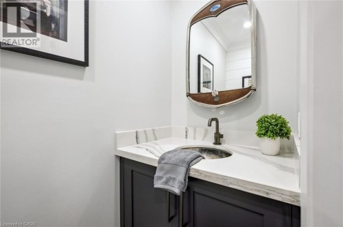 Vanity with dark cabinetry, white countertop, and an undermount basin - 1261 Stephenson Drive, Burlington, ON 