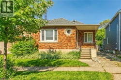 Bungalow-style house with brick siding, roof with shingles, and a porch - 
