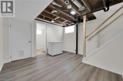 Basement with fridge, wood finished floors, and baseboards - 
