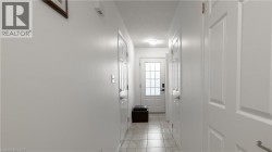 Doorway to outside featuring a textured ceiling - 