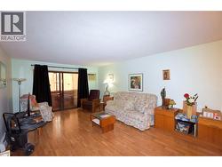 Spacious living room with easy care laminate flooring - 