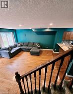 Hardwood flooring, recessed lighting, and a kitchen pass-through with a countertop - 