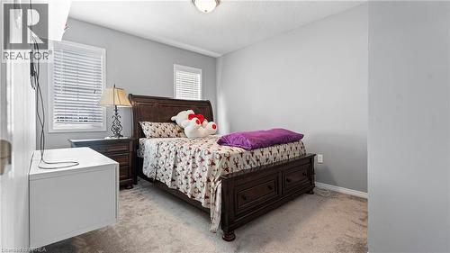 Window treatments, ceiling-mounted light fixture, wall outlets, carpeted flooring, light gray wall paint - 124 Osborn Avenue, Brantford, ON 