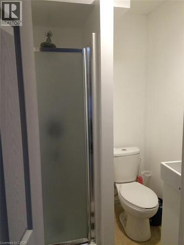 Frosted glass shower enclosure with chrome framing, white toilet, and pedestal sink - 95 Resurrection Drive, Kitchener, ON 