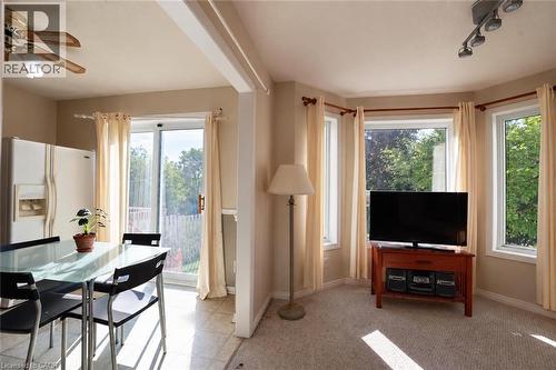 Open concept living area with a bay window, track lighting, and a ceiling fan - 95 Resurrection Drive, Kitchener, ON 