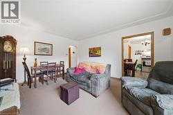 Carpeted living area with white walls and crown molding - 