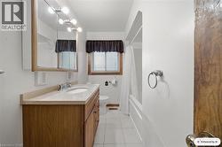 Wood-finish vanity with an integrated sink and light-toned countertop - 