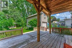 Spacious wooden deck with a covered area and perimeter railings - 