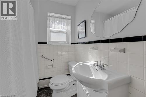 White tiled wall with black accent trim - 824 Brant Street Unit# 9, Burlington, ON 