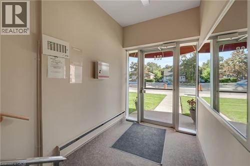 Commercial-style glass entry doors provide natural light - 824 Brant Street Unit# 9, Burlington, ON 