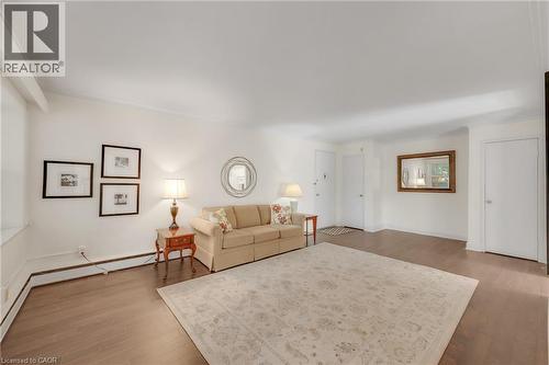 Expansive room featuring wood-finish flooring and white walls - 824 Brant Street Unit# 9, Burlington, ON 