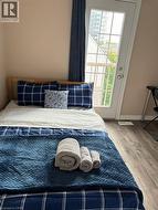 French door with grid-patterned glass, wood-finish flooring, and light-toned wall paint - 