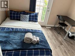 Wood-finish flooring, light-toned walls, and a glass-paned door - 