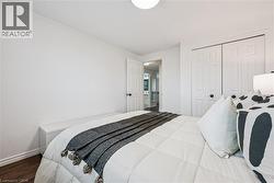 White interior walls, wood-finish flooring, and white bi-fold closet doors - 