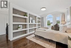 Hardwood flooring, arched window, recessed lighting, built-in shelving, and vaulted ceiling - 