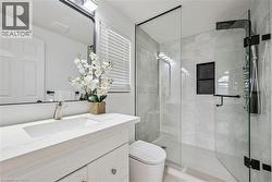 Glass-enclosed shower with a multi-function shower panel and integrated shelving - 