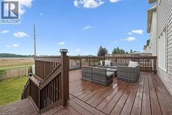Expansive outdoor deck with a dark wood finish, offering generous space for seating - 