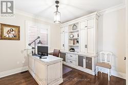 Custom-built office with desk and cabinetry - 