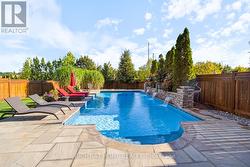 Custom pool with waterfall and fire features - 