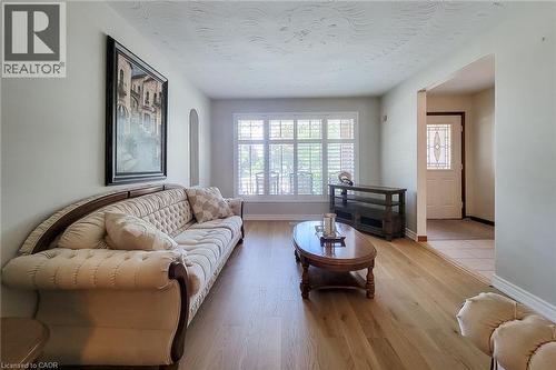 Hardwood-finish flooring, plantation shutters, and a decorative front door with leaded glass - 276 Greencedar Drive, Hamilton, ON 