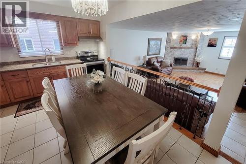 Kitchen with wood cabinetry, stainless steel appliances, and tiled flooring - 276 Greencedar Drive, Hamilton, ON 