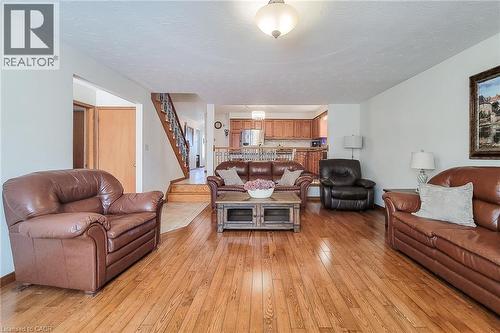 Hardwood flooring throughout, with a staircase featuring wood newel posts and spindles - 276 Greencedar Drive, Hamilton, ON 