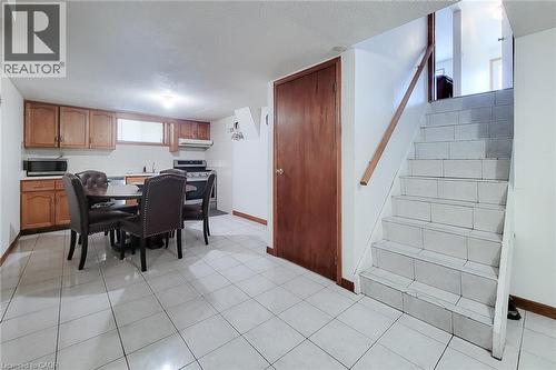 Kitchenette with wood-finish cabinetry and a stainless steel stove - 276 Greencedar Drive, Hamilton, ON 