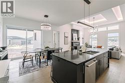 Open-concept living space with recessed lighting and wood-finish flooring - 