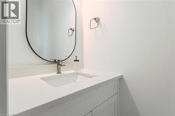 White vanity with an integrated sink and brushed nickel faucet - 