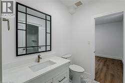White vanity with integrated sink, brushed nickel faucet, and a black-framed mirror - 