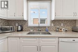 Stainless steel under mount sink, over the sink window bringing in tons of natural light. - 