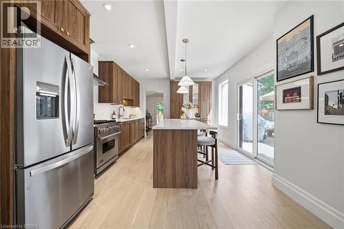 Modern kitchen featuring stainless steel appliances, wood-finish cabinetry, and light wood-finish flooring - 57 Terrace Hill Street, Brantford, ON 