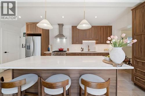 Spacious kitchen island with a white countertop and seating - 57 Terrace Hill Street, Brantford, ON 