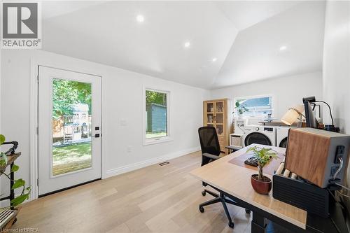 Vaulted ceiling, recessed lighting, light wood-finish flooring, full-light exterior door, and built-in laundry appliances - 57 Terrace Hill Street, Brantford, ON 