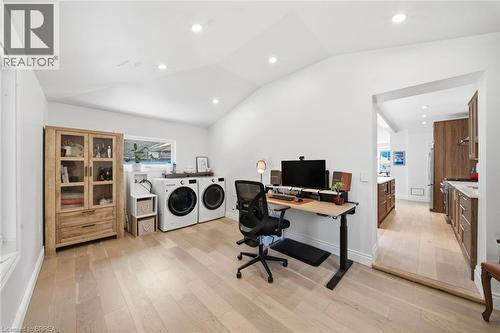 Vaulted ceiling with recessed lighting, light wood-finish flooring, built-in window, and laundry appliances - 57 Terrace Hill Street, Brantford, ON 