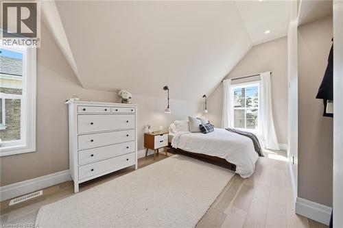 Sloped ceiling design, recessed lighting, wood-finish flooring, two large windows, and wall-mounted sconces - 57 Terrace Hill Street, Brantford, ON 